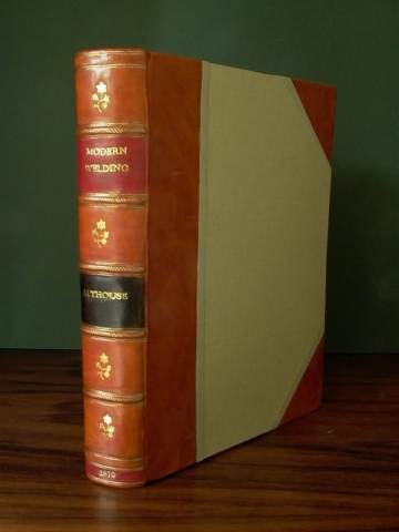 Half binding with leather spine and corner points, and cloth sides.